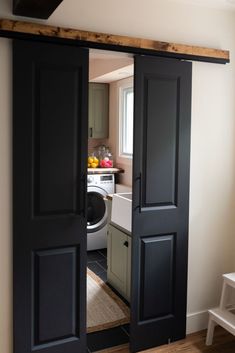 an open door leading to a kitchen and laundry room