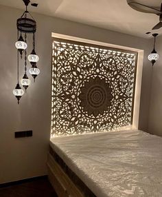 a bed that has some lights on the headboard and it is made out of wood