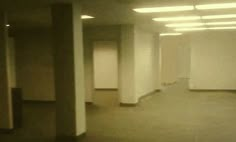 an empty room with no people in it and lights on either side of the door