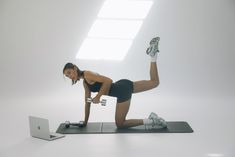 a woman is doing an exercise on her laptop