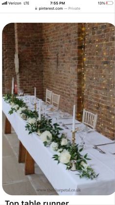 the table is set with white flowers and candles