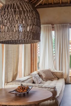 a living room filled with furniture and a large chandelier hanging from the ceiling