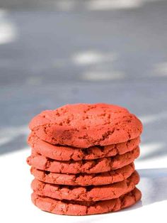 a stack of red cookies sitting on top of a white table