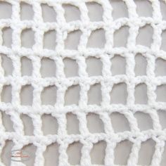 white crocheted fabric with small squares on it