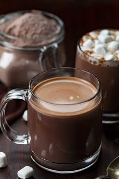 two mugs filled with hot chocolate and marshmallows