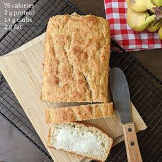 a loaf of bread sitting on top of a wooden cutting board next to a knife