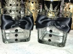 two clear glass vases with black bows on them