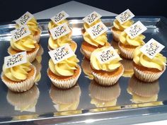 cupcakes with yellow frosting and labels on them