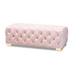 a pink bench with gold legs and buttons on the bottom, in front of a white background