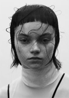 a black and white photo of a woman with frizzy hair