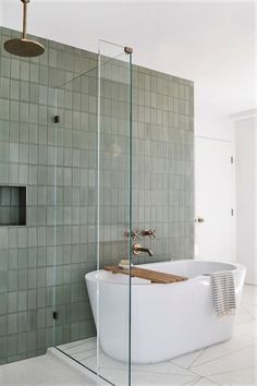 a white bath tub sitting next to a walk in shower