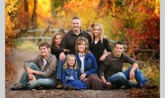 a family posing for a photo in the fall