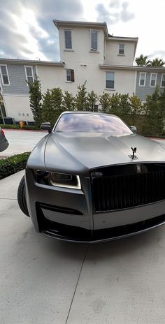 a black car parked in front of a house