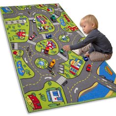 a little boy playing with a play mat on the floor