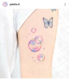 a woman's thigh with bubbles and butterflies on it