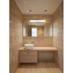 a bathroom with a sink, mirror and light fixture in the corner on the wall