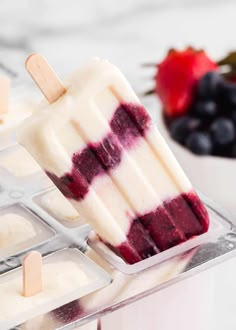 homemade popsicles with blueberries and strawberries in the background text reads 3 ingredient homemade popsicles