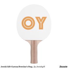 a ping pong paddle with the word joy written on it in orange and white