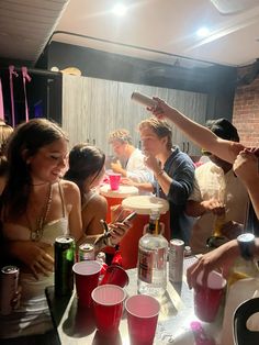 a group of people sitting at a table with drinks and condiments in front of them