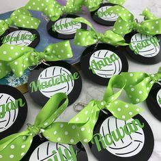 green and black badges with white polka dots on them are being displayed for the camera