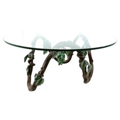 a glass table with branches and leaves on it's base, against a white background