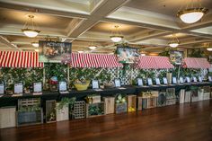 an indoor market with lots of plants and decorations on the tables in front of them