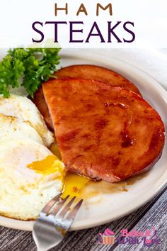 ham steak and eggs on a white plate