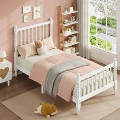 a small child's bed with pink walls and white furniture in a bedroom setting