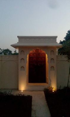 an entrance to a house with lights on it