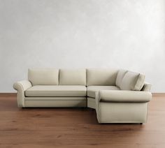 a white couch sitting on top of a hard wood floor next to a wooden floor