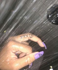 a person's hand with two fingers and the word xx is written on it