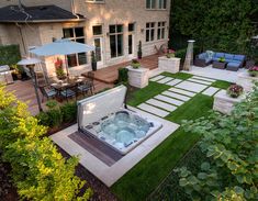 a hot tub sitting in the middle of a lush green yard