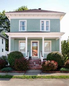 a house that is painted green and white