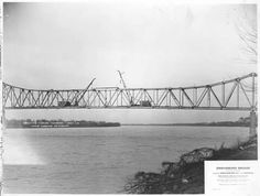 an old black and white photo of a bridge over water