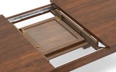 an open drawer on the side of a wooden desk with metal handles and latches