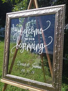 a welcome sign is placed in front of a wooden easel with the words welcome to our beginning written on it