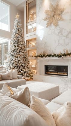 a living room with a christmas tree in the corner and white couches around it