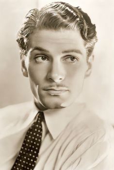 an old black and white photo of a man wearing a tie