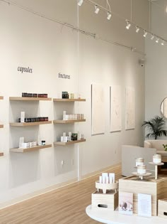 the inside of a salon with wooden shelves