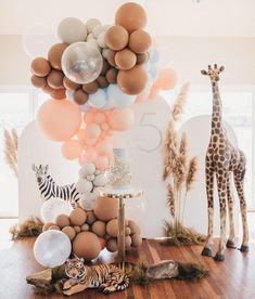 an animal themed birthday party with balloons and giraffes