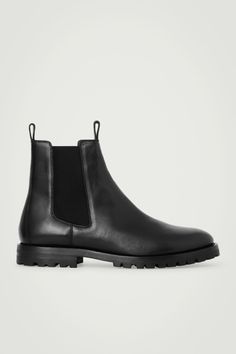 The COS menswear team excel at creating perfected closet staples. Crafted from supple chrome-free leather tanned a deep-black hue, these boots are modeled on classic Chelsea styles and have the trademark elasticated side panels and modern cleated soles. They're innovatively designed with pull tabs at the front and back to prevent creasing the hide when putting them on.  Rubber soles Upper & Lining: 100% Leather, Sole: 100% Recycled rubber Cos Menswear, Black Chelsea Boots, Leather Chelsea Boots, Recycled Rubber, Innovative Design, Leather Working, Panel Siding, Wardrobe Staples, Chelsea Boots