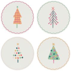 four plates with christmas trees on them in different colors and designs, each decorated with colorful dots