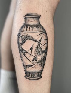 a black and white image of a vase with birds in it on the right arm