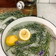 lemons, rosemary and lavender are in a pan on the stove top with water