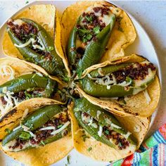 some tacos are arranged on a plate