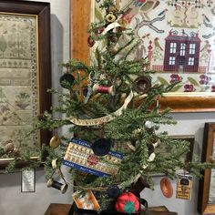 a small christmas tree is decorated with ribbons