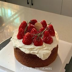 a cake with white frosting and strawberries on top