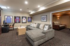 a living room filled with furniture and pictures on the wall next to a flat screen tv