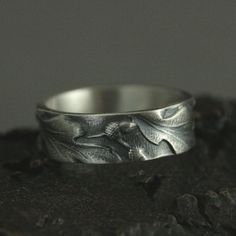 Band Tree Ring Nature Inspired Band Oak Leaf Ring Acorns Band Embossed Ring Silver Promise Band 6mm Oak Ring Silver Pattern Band Blazer Arts ☆ MATERIALS: Sterling Silver ☆ DIMENSIONS: 6mm Wide by 1.5mm Thick Our modern lives are hectic and we are inundated with so much technology that it's easy to think we are separate from nature. We understand that it can be difficult to take the time to get back to nature, and our sterling Oaken Band offers you a way to take it with you wherever you go. This Promise Band, Tree Ring, Tree Rings, Leaf Ring, Oak Leaf, Back To Nature, Sterling Silver Bands, Engraved Rings, Ring Silver