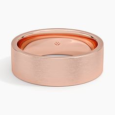 a rose gold wedding ring on a white background